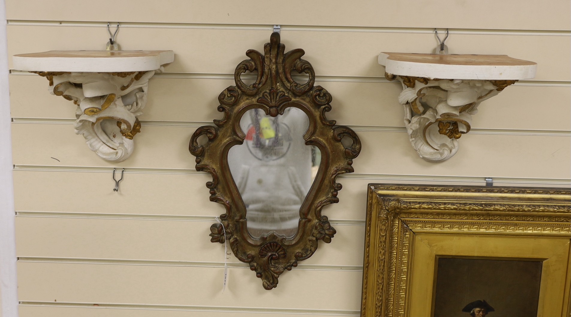 A girandole mirror and two wall brackets